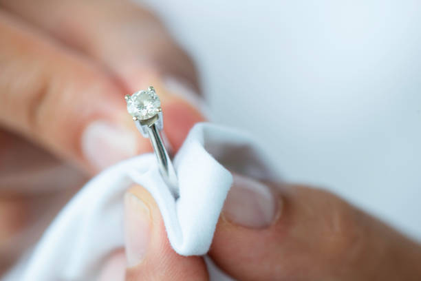 Jeweler is polishing a diamond ring.